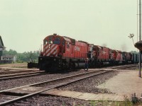 A harsh overhead sun was the reason I elected to shoot from this odd angle at Guelph Jct. The only clue that this is an image from the Jct is the building on the left; perhaps a former hotel or boarding house. It is still in existence. Everything else is gone. The station and the power. The most distant track in the photo was removed this past fall, and the rest has been rebuilt (elevated). CP 4712, 4553, 5752 and 4508 roll eastward as the orders are hooped up.