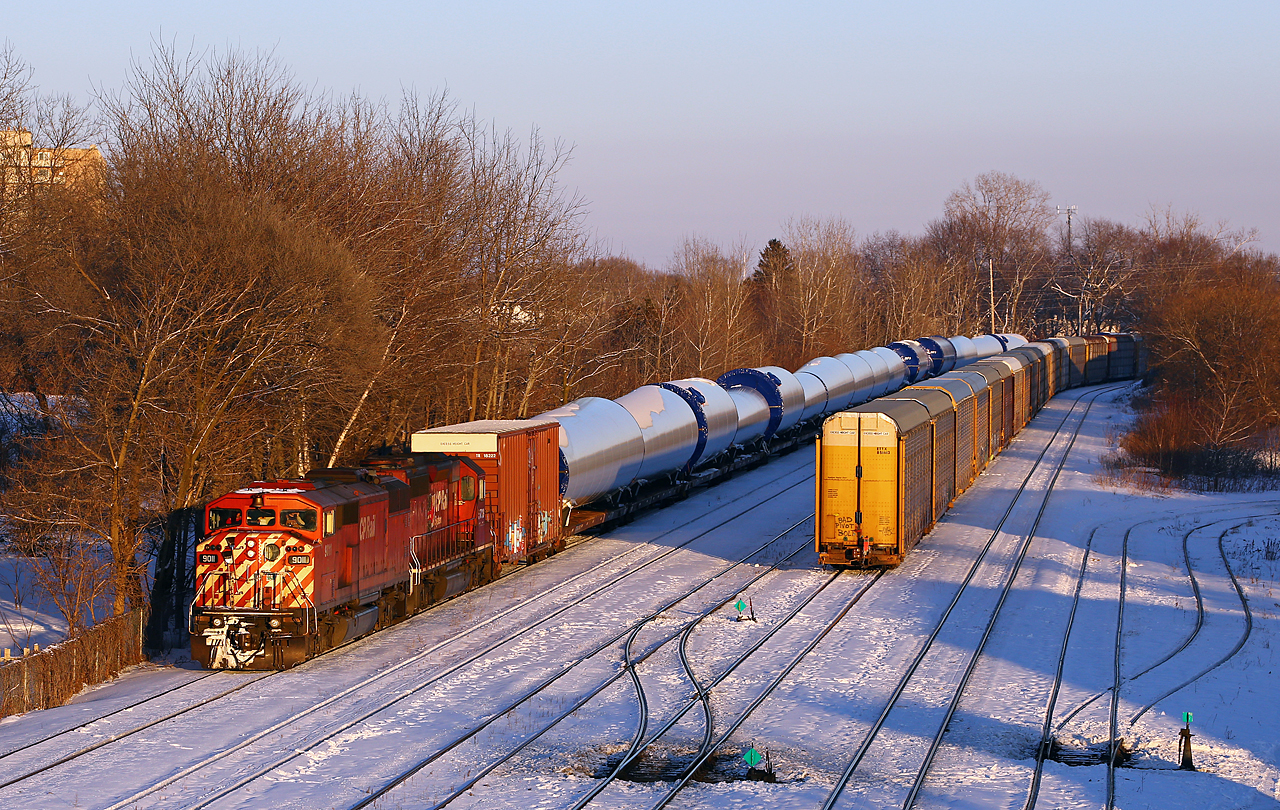 When I saw the consist of today's DIM train, I was sure glad that I stuck it out in the cold waiting for it! Only a few minutes before sundown, the train approaches its' recrew stop at London, with one of the few remaining SD40-2F's leading the way (CP 5788 trailing). The train was delayed by a hot wheel 2800' back in the train and nearly ran out of daylight before reaching the west end of the Galt sub. Fortunately, CP 240 (at right) was relatively short today, only 4200', so it allowed a short gap in the long late afternoon shadows. I would have been happy seeing an SD60 leading, so I guess the Red Barn is gravy!