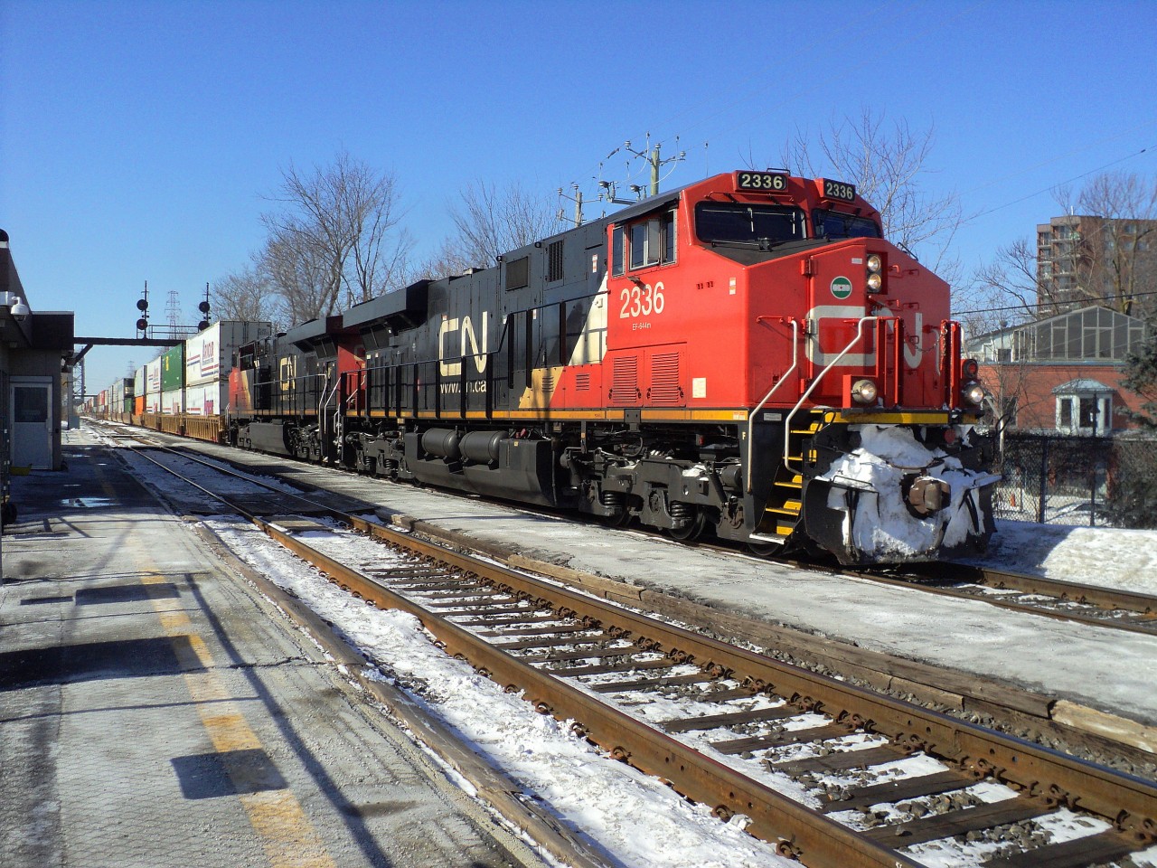 CN-2336 leading loco follow of CN-2237 both ES-44-DC a convoy of containers going in the Maritimes on CN-rte 120 passing by St-Lambert on a nice sunny and cold day -17C was about 12,000 feets