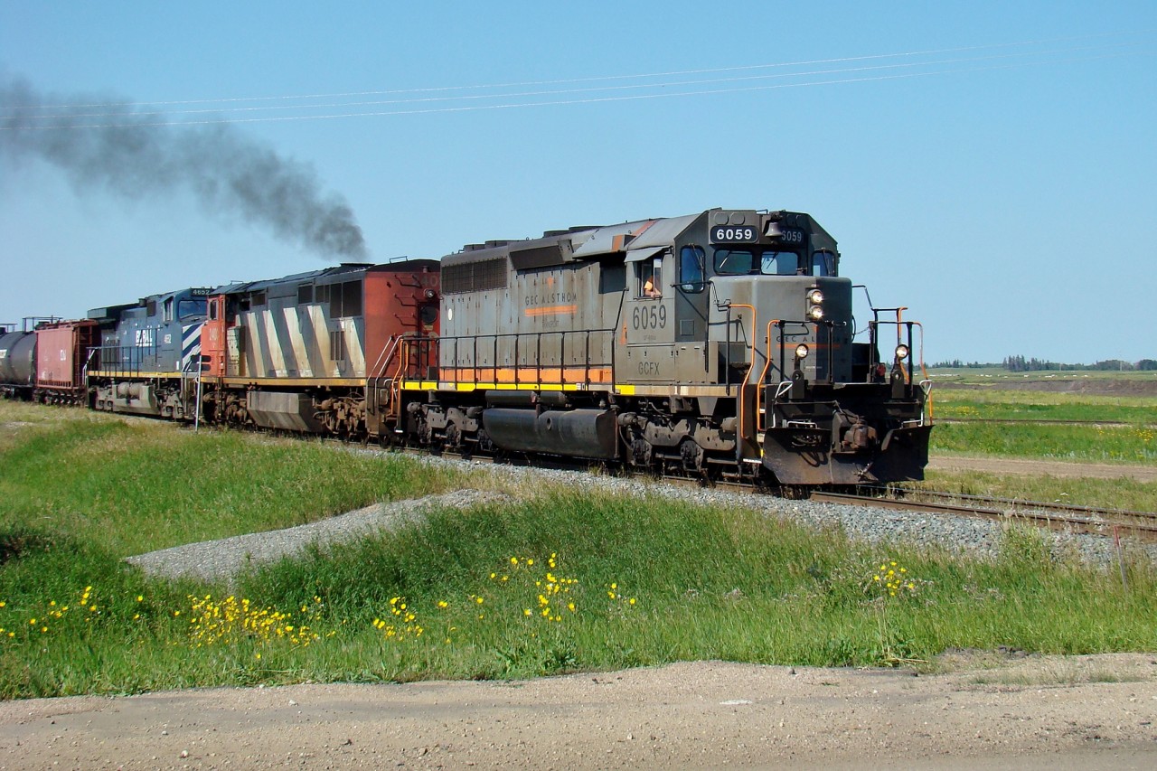 GCFX 6059, CN 2403, and BCOL 4652 depart from Scotford Yard with CN 452 to Winnipeg.