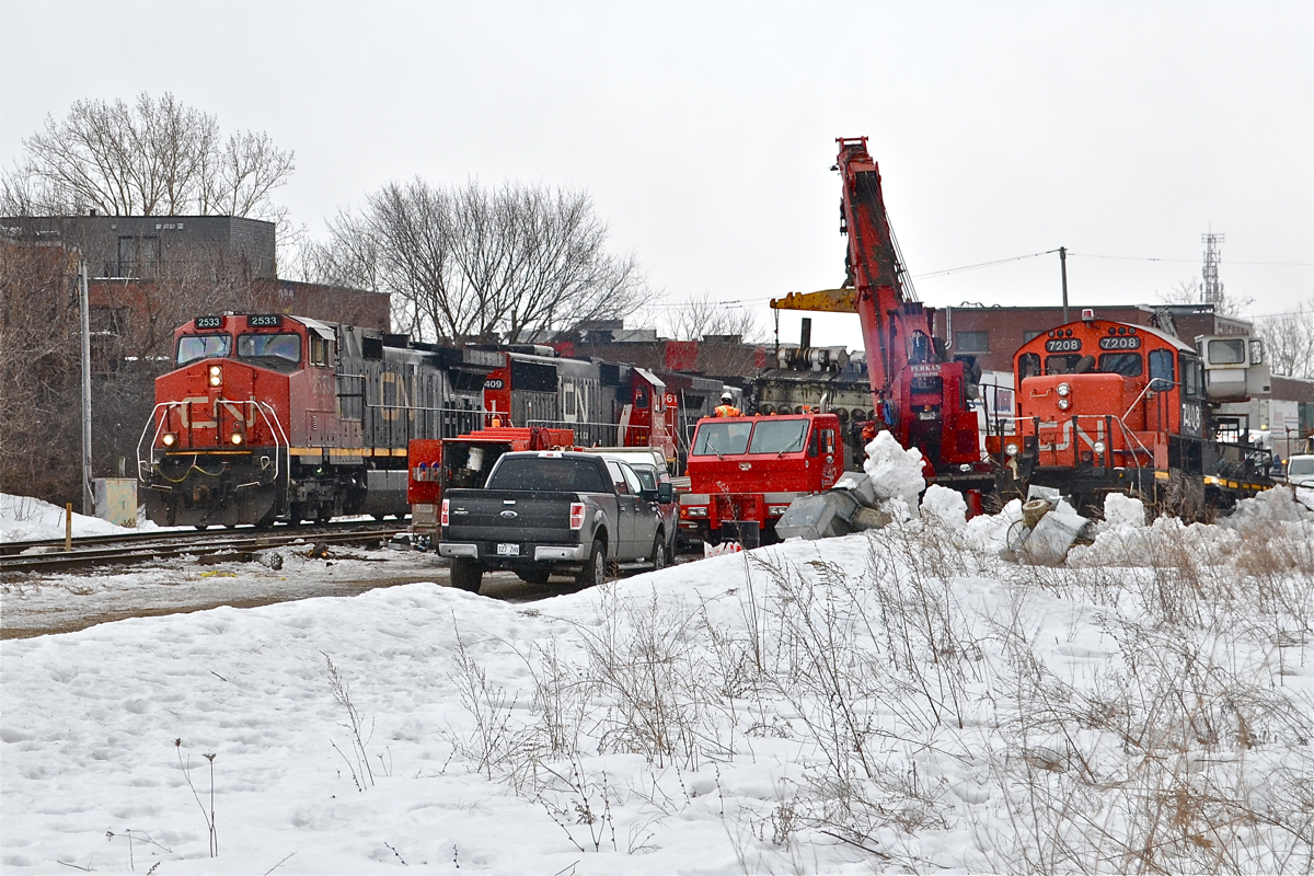 CN 120 with CN 2533, CN 5409 & CN 2561 passes CN 7208 which is being scrapped on-site. It was involved in a sideswipe and a derailment very early Sunday morning in the St-Henri neighbourhood of Montreal. For more train photos, click here.