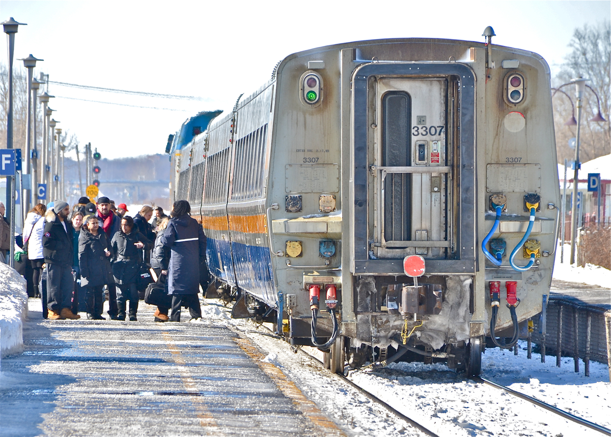 Passengers are anxious to board VIA 65 as it makes its station stop at Dorval as it is a very windy and cold morning. At the head end is VIA 907. For more train photos, click here.