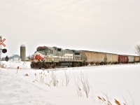<i><b>Still stranded.</b></i> MMA 8583 and the 9 cars behind it have been stranded on MMA's Stanbridge Sub since last summer. The reason for this is the poor condition of the track, which led to Transport Canada embargoing the line, and also led to a car derailing slightly further north, thus cutting off the only way this train could be moved by rail. For photos of this engine from last fall, click <a href=http://www.flickr.com/photos/mtlwestrailfan/10235725256/in/set-72157636482784943/>here</a> and <a href=http://www.flickr.com/photos/mtlwestrailfan/10235078644/in/set-72157636482784943/>here.</a> For more train photos, click <a href=http://www.flickr.com/photos/mtlwestrailfan/>here.</a>
