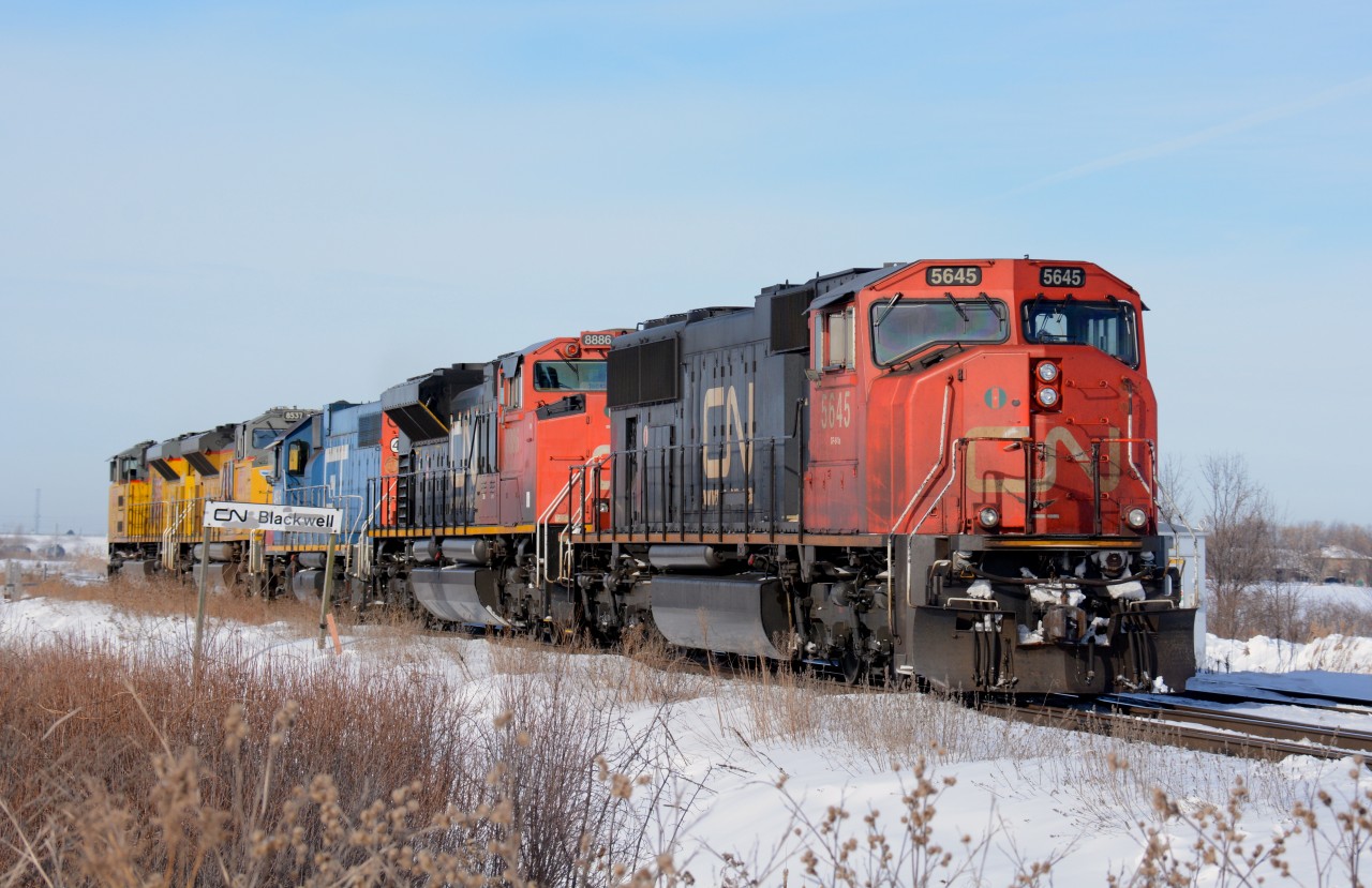 CN5645 leads CN8886, GT4906, UP8537 and UP8595 eastbound at Blackwell siding Sarnia, Ontario.