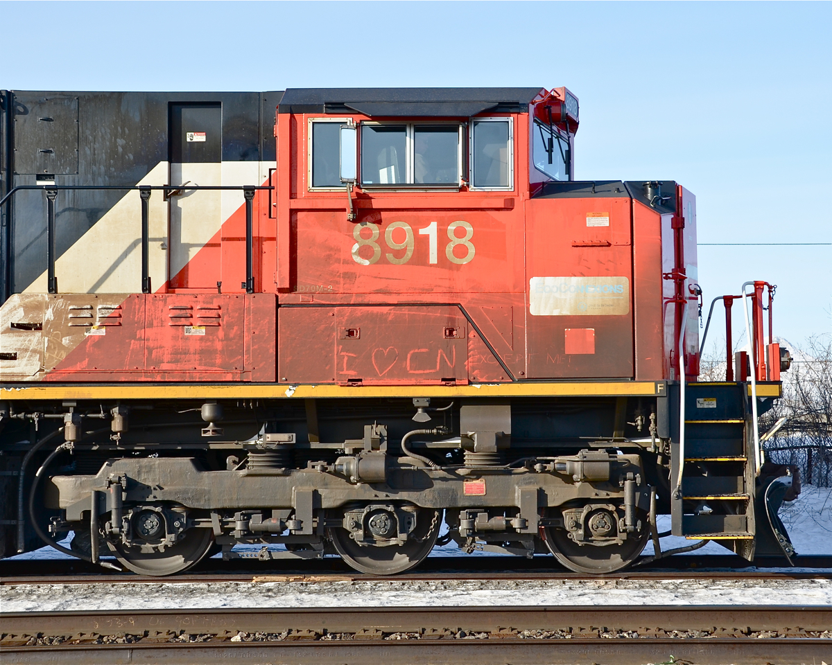 "I heart CN" "Except me!" That is the message scrawled in the dirt on the cab of CN 8918, temporarily stopped at Dorval on CN 106, with CN 5431 trailing. For more train photos, click here.