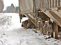 <i><b>Derailed.</b></i> CGOX 3002 derailed on MMA's Stanbridge sub last summer and it (along with CNA 385011) has been sitting there ever since, as Transport Canada embargoed the line soon afterwards. This track is in very bad shape. In the distance can be seen MMA 8583, also sitting there since last summer. For more photos of this derailed car, click <a href=http://www.flickr.com/photos/mtlwestrailfan/12549769615/in/photostream/>here</a> and <a href=http://www.flickr.com/photos/mtlwestrailfan/12549951783/in/photostream/>here.</a> For more train photos, click <a href=http://www.flickr.com/photos/mtlwestrailfan/>here.</a>