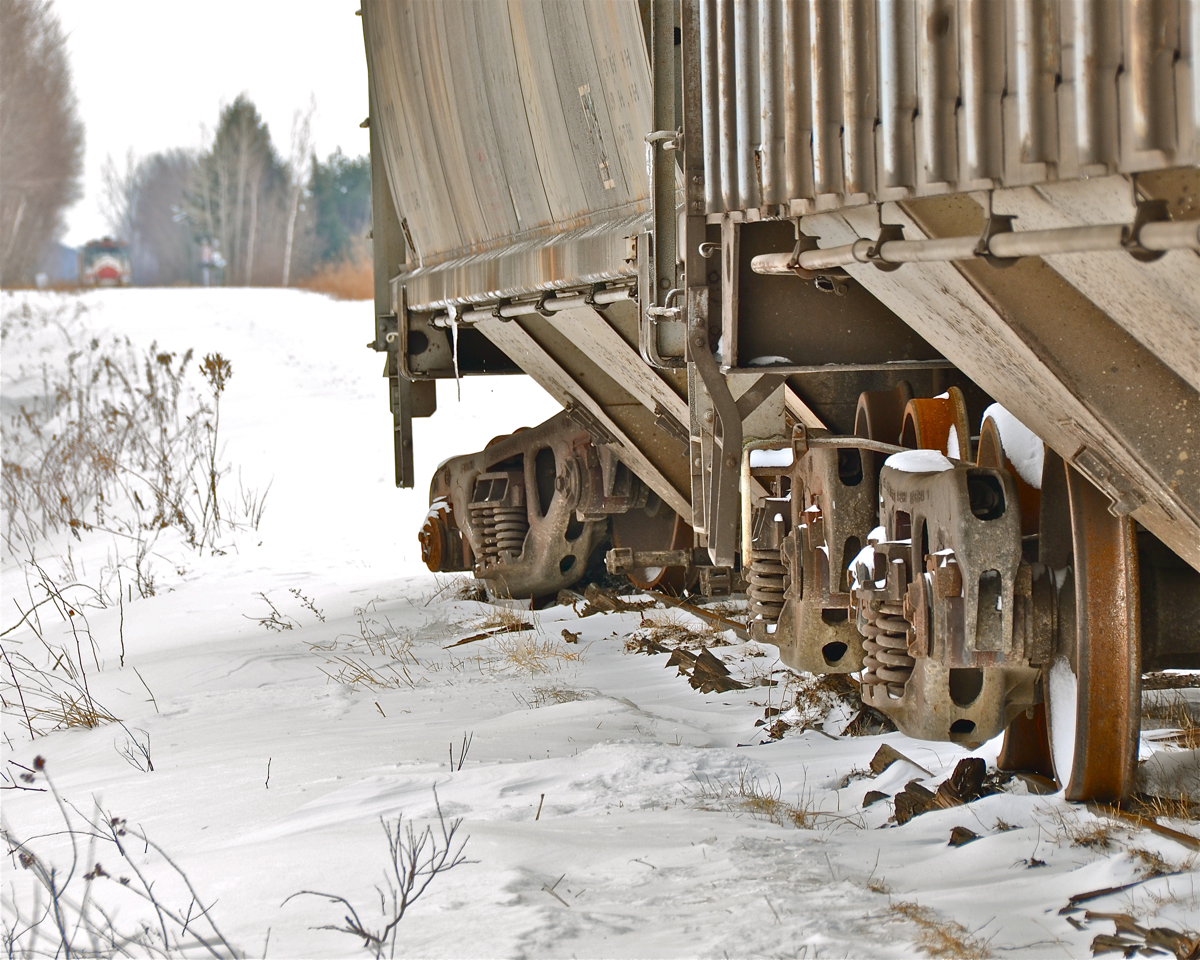 Derailed. CGOX 3002 derailed on MMA's Stanbridge sub last summer and it (along with CNA 385011) has been sitting there ever since, as Transport Canada embargoed the line soon afterwards. This track is in very bad shape. In the distance can be seen MMA 8583, also sitting there since last summer. For more photos of this derailed car, click here and here. For more train photos, click here.