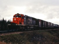 It's a gloomy wet afternoon in May 1973 as CN 5190 is in charge of a westbound mixed freight near Edson, Alberta.