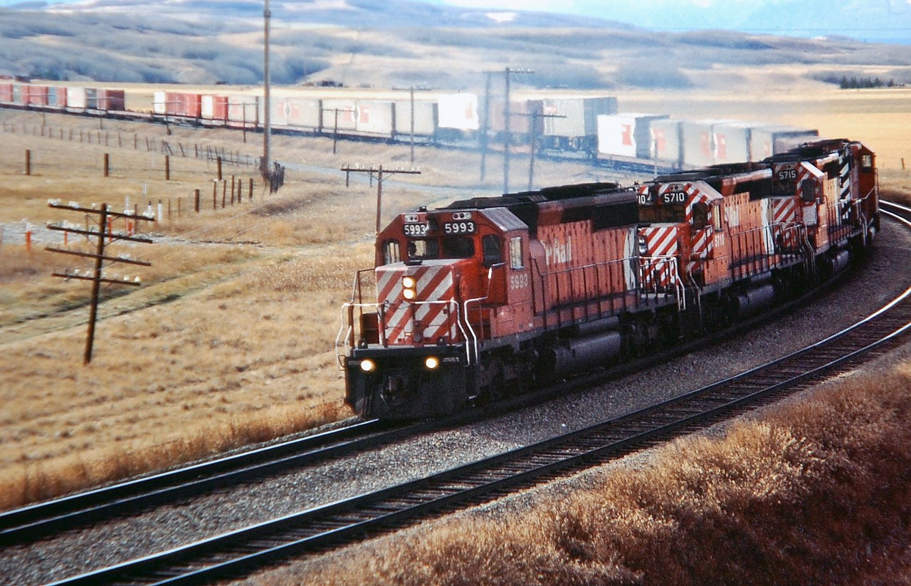 Four SD40-2's headed by CP 5993 are approaching Cochrane with an eastbound Intermodal.