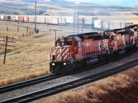 Four SD40-2's headed by CP 5993 are approaching Cochrane with an eastbound Intermodal.