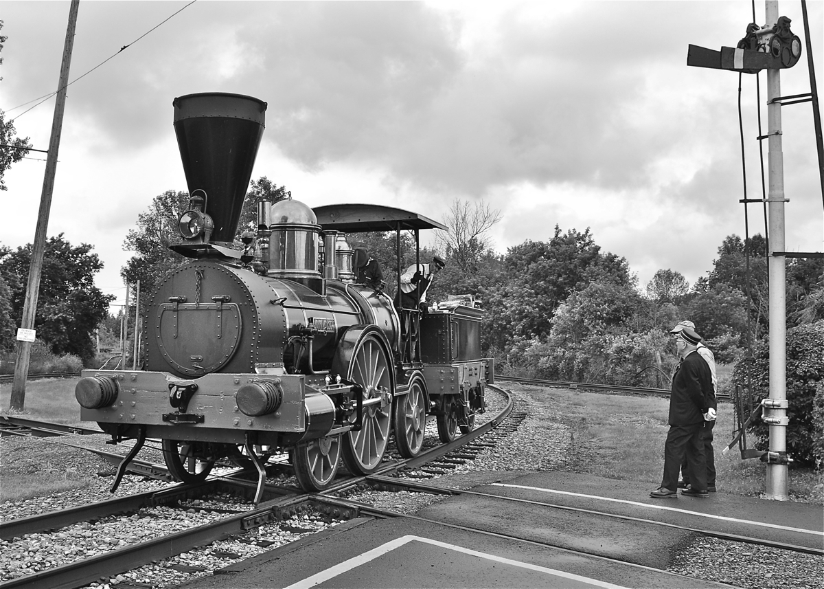 'John Molson' is a 2-2-2 steam engine built by Kawasaki during the 1970s as a replica of one of Canada's first steam engines. Here it is passing over the diamond near Barrington Station at the Canadian Railway museum. For more train photos, click here.