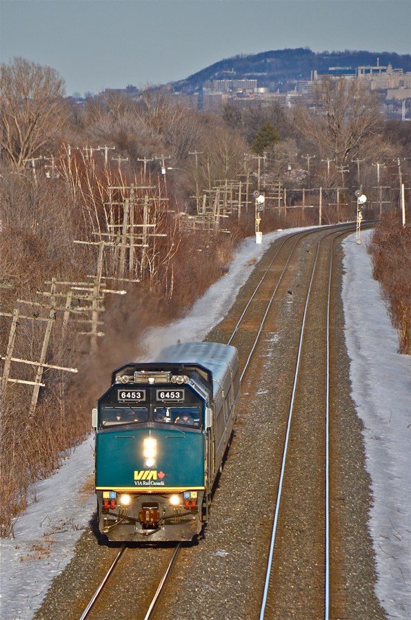 VIA 6453 speeds through Montreal's West Island with VIA 59 in tow. In the background is Mount Royal. For more train photos, click here.