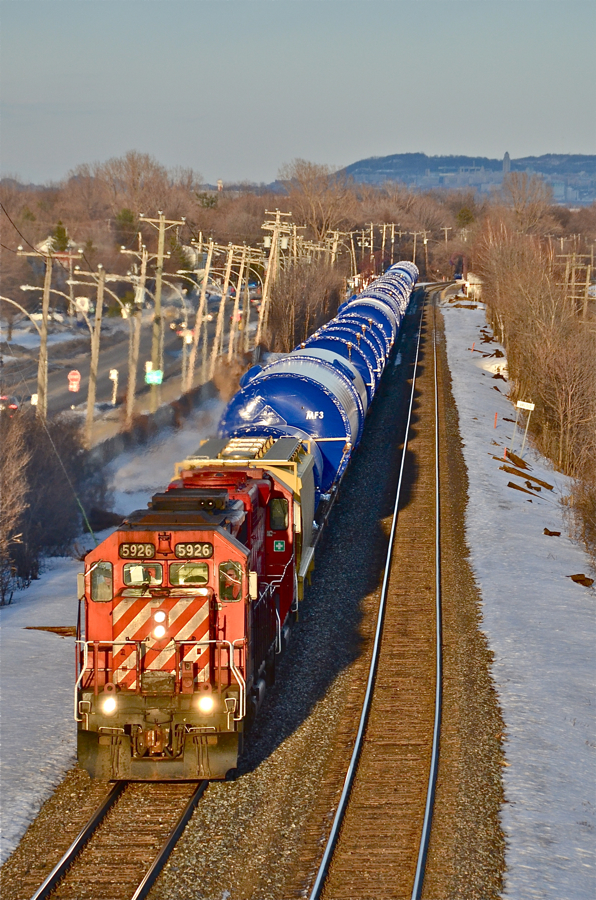 Windmill train. CP 5926 & CP 4506 head west with a relatively short train of windmill tower sections about 45 minutes before sunset. In the background is Mount Royal. For more train photos, click here.