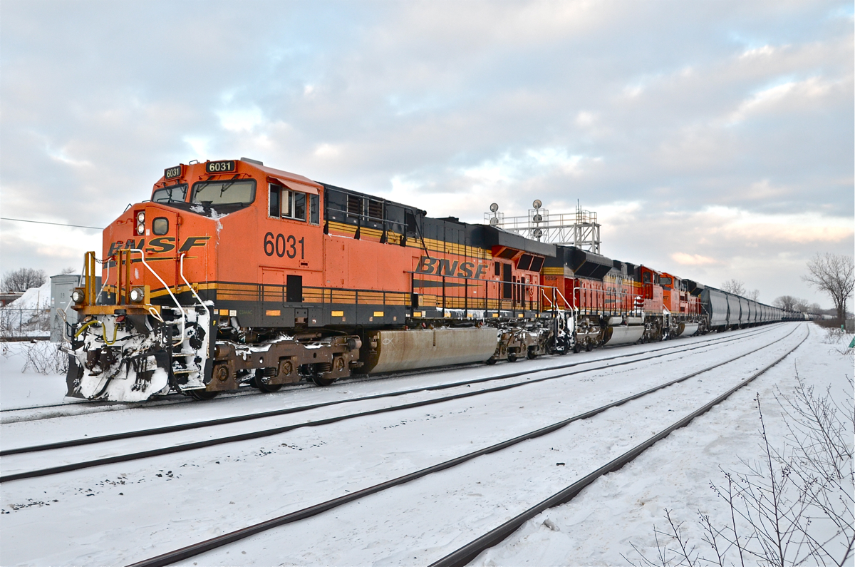 Tripe Swoosh. With 3 BNSF engines in the 'swoosh' paint scheme (BNSF 6031, BNSF 9255 & BNSF 9243) that came in early in the morning on CN 720 (loaded oil train), CN 377 slowly begins heading west through Dorval. I'm dedicating this photo to my wife (Tamara Fisher) for waiting 3 hours at the nearby VIA Dorval station while I waited for this slightly later than usual train.... We were on our way to Ottawa! For more train photos, click <a href=http://www.flickr.com/photos/mtlwestrailfan