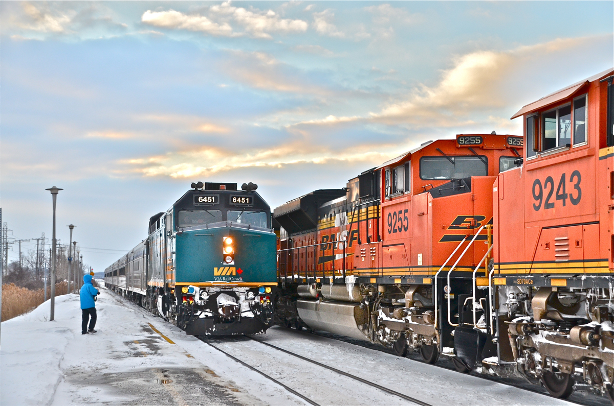 Yep, this is Canada alright. Although the BNSF locomotives might mark this as a shot taken in the U.S., the presence of VIA 6451 at left (leading VIA 64 to its station stop at Dorval) establishes this as a Canadian location. At right CN 377 (with BNSF 6031, BNSF 9255 & BNSF 9243) very slowly heads west. On the left we see rp.ca contributor Nicolas Houde who just caught the same meet. For more train photos, click here.