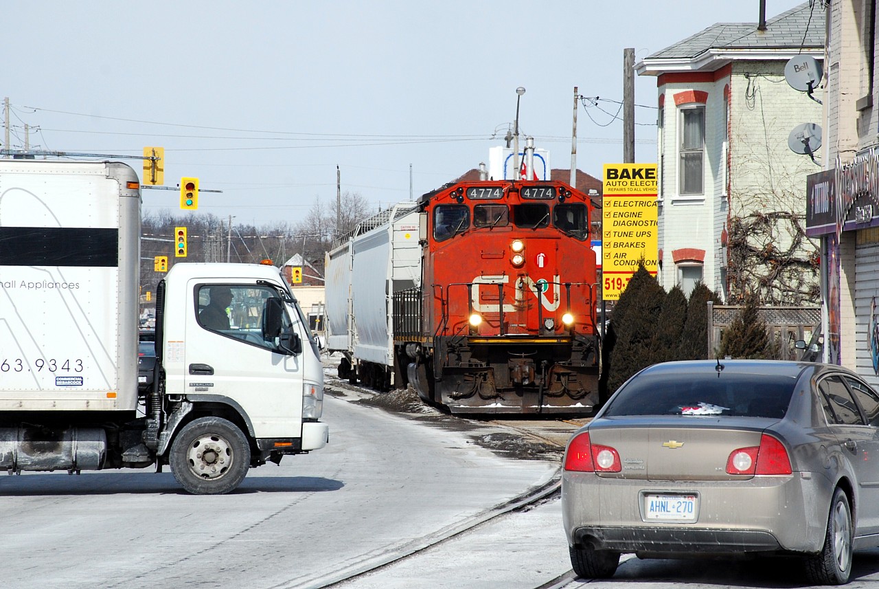 Motorists on Colborne Street and Clarence Street go about their noon hour business, seemingly oblivious to the approaching train. No one was in any grave danger as the train had to stop so a crew member could get off and toggle the switch to place the traffic signals in the railway pre-emption phase. In a matter of months this line could be history.