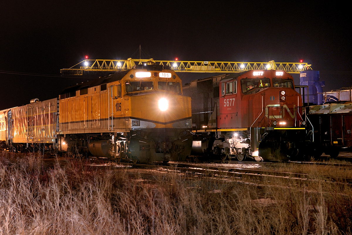 Enroute back home to my parents home in southern Ontario I would sometimes stop in at the Companion Motel in Hearst to spend the night. The reasoning: because it backed onto the rail yard in Hearst which hosts the local for the ONR on their Kapuskasing Sub (... and Pagawa Spur) and the CN freight and passenger which comes off the Soo Sub.
One night in March 2010 while on one of these long journey's, I grabbed a room at the motel and took a spin to the back parking lot, CN SD75i 5677 idled in the yard next to a pair of ONR Geeps. I went to my room, kicked up my feet and watched some tv. Around 21:00 I heard some squealing wet brakeshoes against steel wheels. I looked out and found the northbound passenger had arrived with CN F40PH 105 had arrived with train 632. I pulled out the tripod and took the camera out to snap a few night exposures. It was a cold, windy March night and flurries were in the air, visible in the headlight of the 105.