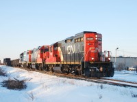 CN 439 pulls up to Airport road in Windsor with a usual sized train pulled by 3 geeps one of which is GTW 4927.