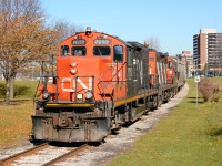 CN7052 leads CN4136 through Sarnia with hopper cars from the Cargill grain elevator.