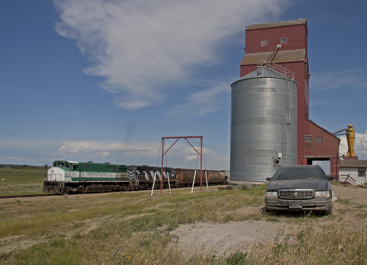 Great Western sets out an empty grain hopper at the elevator in Cadillac SK.