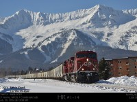 Empty potash 672 with 9804 and 9767 working eastbound on the Cranbrook Sub about to cross the 13th Street road crossing with the Lizard Range and the Fernie Ski resort in the background.