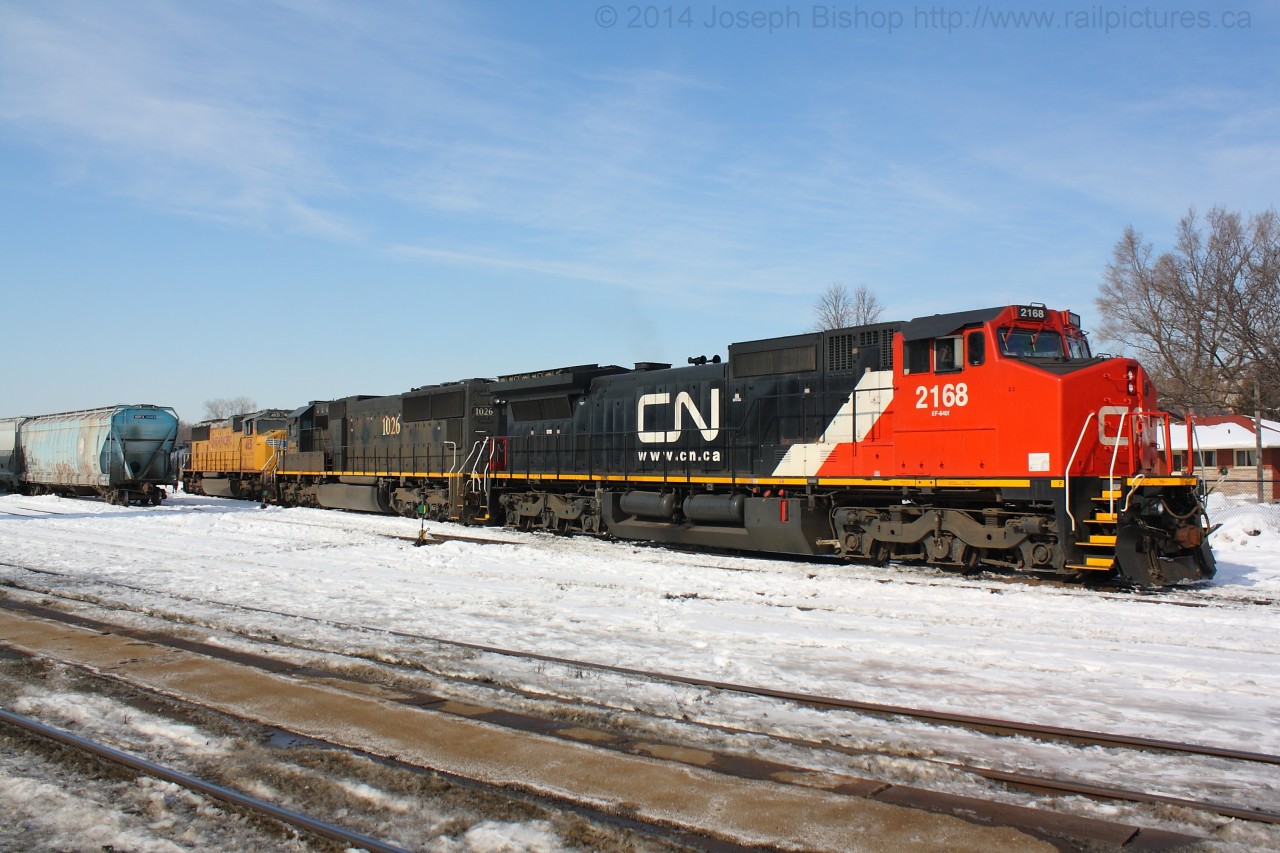 CN 396 is sitting in the Brantford yard waiting for their clear signal back onto the North track after completing their drop.  Their colourful consist was CN 2168, IC 1026, UP 4651.