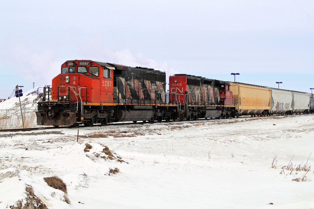 SD40-2(W)'s CN 5287 and 5246 take Dow hopper cars along the Fort Saskatchewan Industrial lead from Scotford Yard.