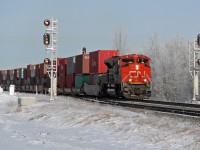 On a sunny but cool frosty morning SD70M-2 CN 8934 heads an eastbound intermodal through Ardrossan.