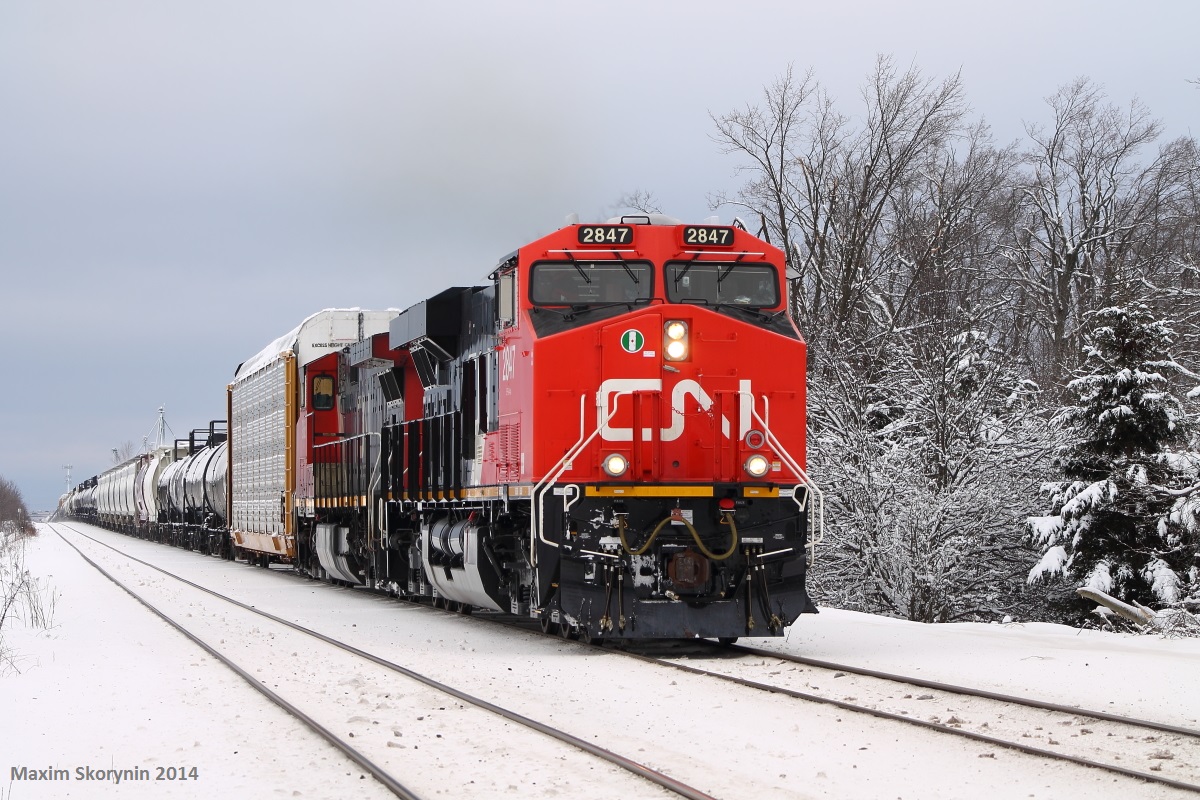 Brand new CN ES44AC! On point of an extra 301 mixed freight, one of the brand new ordered Evolution Series 4400 horsepower Alternating Current (ES44AC) engines leads another GE, past Heritage Road just east of Georgetown near Peru, ON. This is also my first CN ES44AC ever caught. Units were: CN 2847-CN 2668.