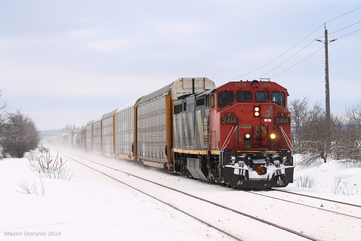 CN 2414 solo is doing track speed past Heritage Road just east of Georgetown, where it met CN X301. A winter wonderland after yesterdays all day snow fall.