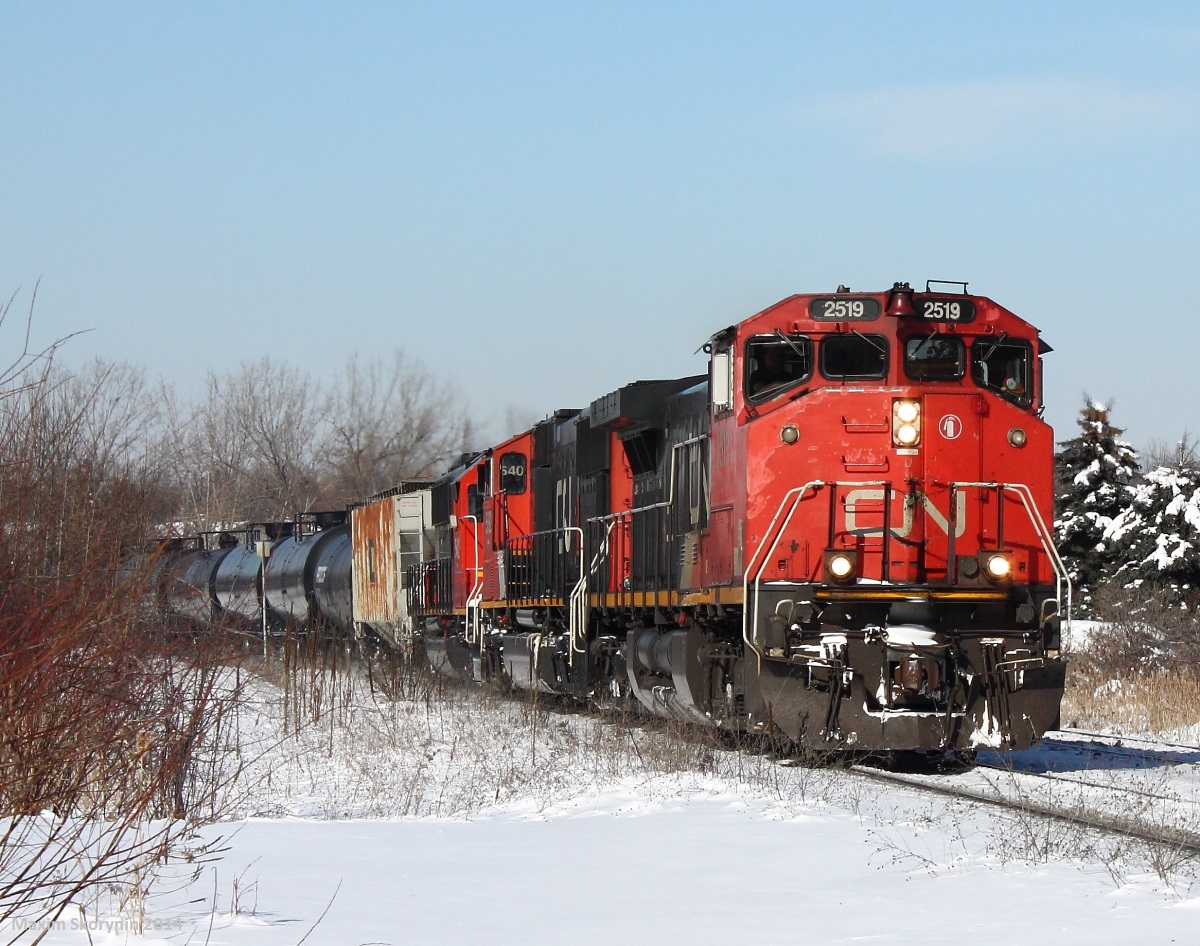 With a weekend with perfect light and not a single cloud in the sky, knowing about this decent 302 was coming, I decided it was time to take a break from school and try out this new location, which I had never shot at before. Here is CN 302 which was restricted to 40 MP/H on the Bala subdivision just to wheel problems, and diverged onto the Canadian National York subdivision bound for Macmillan yard, the largest yard of its kind in the country. Moments after 302 passed, VIA 2 raced him on the other track and almost hit a pedestrian trying to outrun it, tired of waiting.