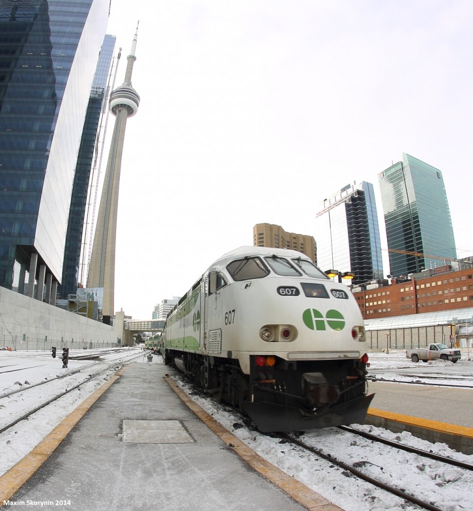 GO Tranit's brand new livery paint scheme....Here we see GO 607, one of the engines painted in the new scheme, arriving on a Eastbound GO Train bound for Oshawa, ON, with Canada's "CN Tower" in the background along with a few skyscrapers.
