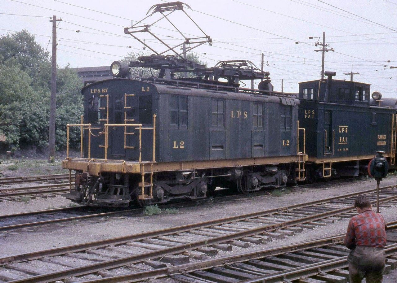 One of London and Port Stanley Railway's 60-ton GE boxcab electric units, L2, switches their London Yard in 1959. Coupled behind it is flanger car FA1.

[Editor's note, L2, built in 1915, survives today at the Halton County Radial Railway museum]
