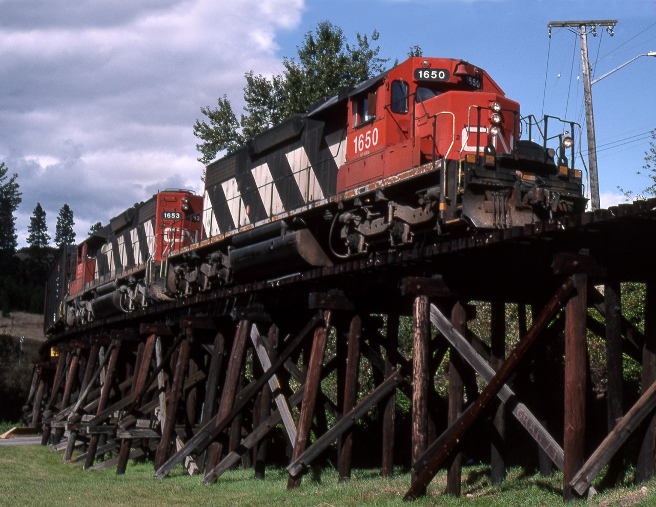 A pair of CN SD38's depart Vernon BC bound for Lumby crossing the Wood Trestle at Lumby Junction at Kalamalka Beach