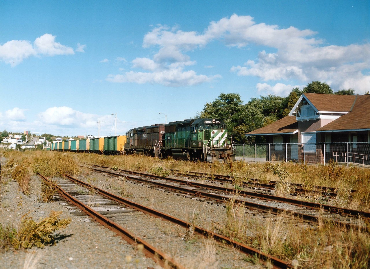 CBNS 5004 and leased HATX 910 roll southward past the old boarded up passenger depot with what looks to be a string of empty hoppers of Devco heritage. Shortly after this photo the CBNS unit was transferred to the Indiana & Ohio Rwy. The northern area of Cape Breton....actually ALL of it, has fallen on economic hard times.