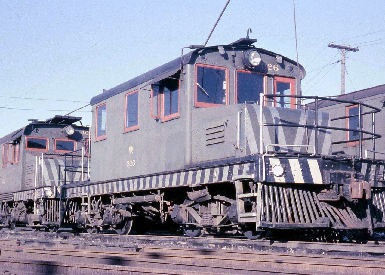 More of Oshawa Railway's electric locomotives, or "motors" as many railways called them, at the OR's shops off Hillcroft St. Here we have motor 326 coupled to 402, both of slightly different designs. Note the pole hung between 326's trucks, used to for moving or "poling" cars on adjacent tracks by way of the round holes or poling pockets on the pilot end. A somewhat dangerous practice that many railroads abandoned.