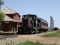 Southern Prairie Railway's ex MEC GE 44t 15 and a former DLW coach Mount Holly gets ready to depart for a return trip west to Horizon Sask on Fife Lake Railways ex CP Assiniboia Sub. The Station was formerly from Simpson Sask. but was of a similiar style as the original Ogema Station.. 