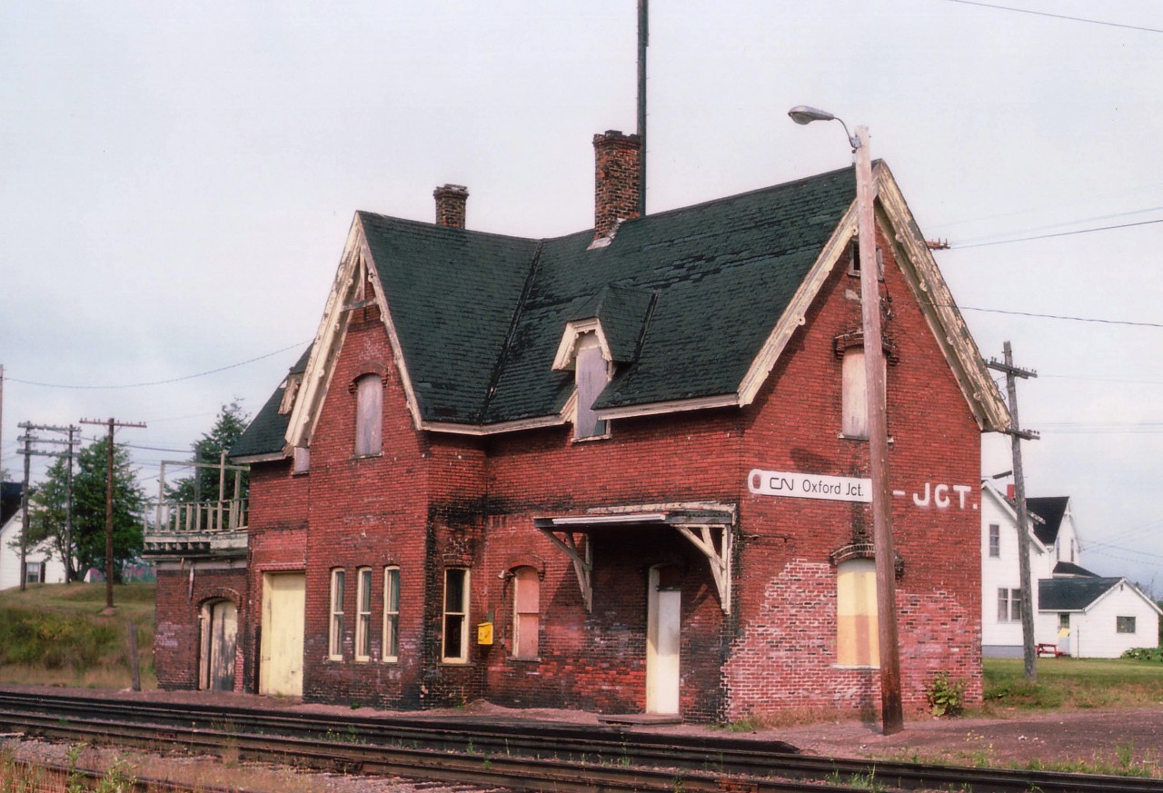 CN Oxford Jct is a classic example of an early fully-equipped Intercolonial Rwy depot from back in the late 1800s. Passenger, freight, MoW and agent living quarters all in one.Immediately off to the left out of view and behind the building is the former line to the Salt Mine at Pugwash; now but a spur; the mine reverting to trucking salt to a location about 200 yds out of view since the 1980s. I understand this is now a designated Nova Scotia heritage building, and is still in situ.