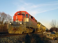 Rolling west into the 4:30pm sunset, RailAmerica GP40 4096 heads up the matching LLPX duo of 2210 and 2236 on Goderich Exeter Railway train 431, crossing over <a href=http://www.railpictures.ca/?attachment_id=11931><b>Fletcher's Creek</b></a> while exercising running rights on Canadian National's busy Halton Subdivision from MacMillan Yard back to the Guelph Sub (at Georgetown). 4096 is back on her old stomping grounds, as she was built in 1966 for CN as 4006 and later renumbered 9306 before being retired and sold. <br><br> This segment of track in Brampton was undergoing triple tracking for increased GO Transit train service, which would branch off less than a mile away, just east of the diamond and station downtown. The new bridge span over Fletcher's Creek can be seen installed in the background for the future 3rd track, which would run where the photographer is standing. About 3 cars down is the switch to the <a href=http://www.railpictures.ca/?attachment_id=3744><b>Dixie Cup Spur</b></a>, serving the Georgia-Pacific (former Dixie Cup Company) plant off Queen Street. The switch would be removed for installation of the third track and never reinstalled - the spur would fall into disuse and be ripped up by April 2013.
