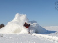 <b>The infamous Salford Cut can teach you a valuable lesson</b> - one of the most notorious spots for drifting on the Port Burwell sub  located just north of the OSR Shops in the middle of a farmers field. Even though a train had been through this spot earlier for CAMI and the plow of the locomotive would cast some snow aside, the plows flange blades and wings heave considerable amounts of heavy wet snow nearly 30 feet into the air. Seconds later I was hit by two waves of snow as I bravely turned and ducked - the first wave -  snow from the flanger blades,  lifted from inches below the rails and thrown by momentum along the sleek plow curves - hit me like a thousand snowballs thrown in my direction. However, the second wave - from the mighty wings of the plow - each outstretched to their limit, flings snow forcefully to each side - this second wave hit me with a mighty wallop like two dozen wheelbarrows full of snow thrown at you. Gravity won this round and like so much snow before it, took me to the ground. Moments later I rose from the debris to watch the train finish the cut, and back up to take a second pass, to which I stood further back in awe of the mighty power that I had just witnessed.