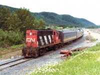 Campbellton, N.B. based CN RS-18 #3669 assists disabled passenger #622 on its daily Matapedia-Gaspe run which is usual just a BuddCar consist. This trackage is now operated by Societe du Chemin de fer de la Gaspesie, which has 4 old x-CP MLW RS-18s in its stable.