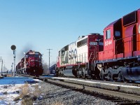 SOO 6619 sits in the siding with Extra 501 West as SOO 6616 charges eastward with Extra 502 at mile 94.1 on the CP's Windsor Sub.