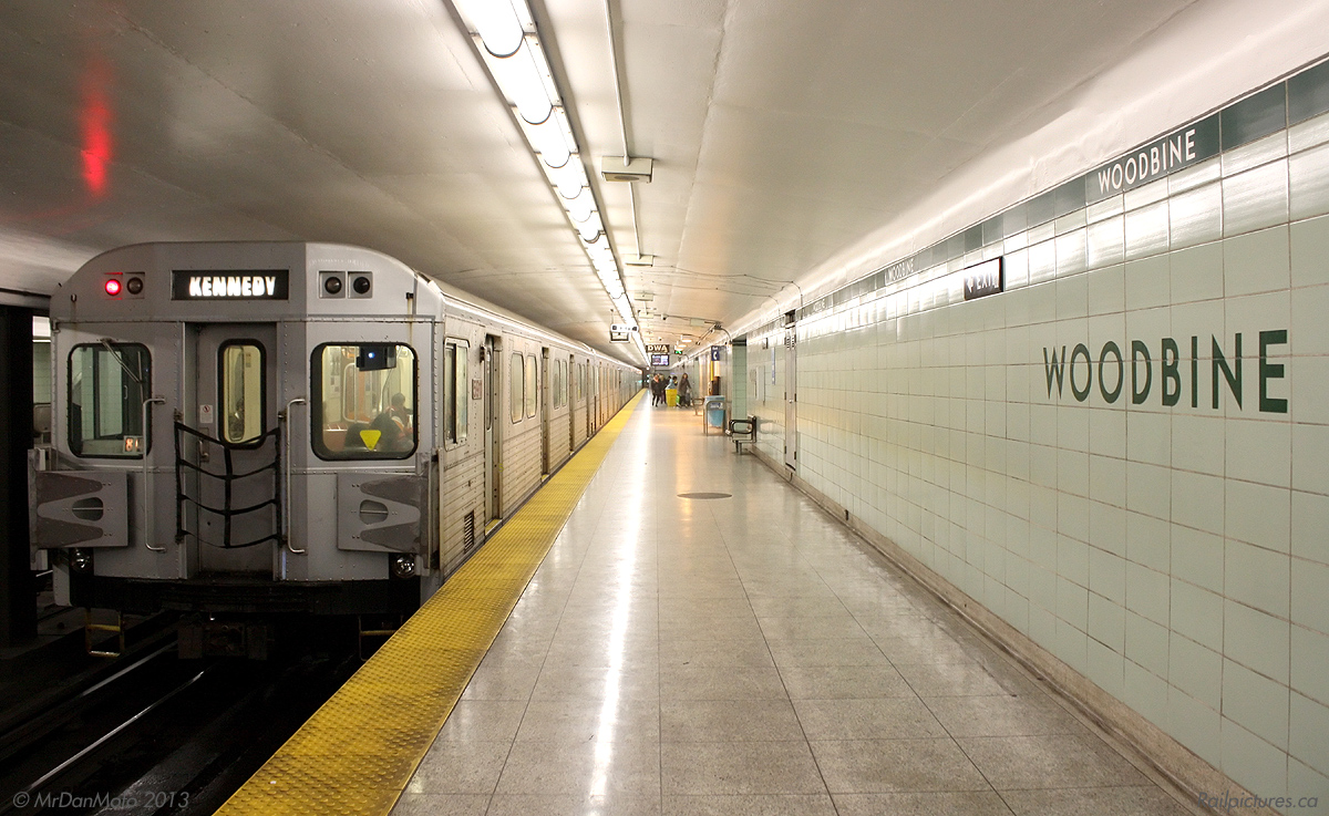 Heading westbound in the evening, TTC 5911 trails a train of sister H6 cars at Woodbine Subway Station, loaded with passengers heading for points west as well as the Yonge, University and Spadina subway lines. The evening flow from the downtown core is in the opposite direction (eastbound) on is part of the Danforth line, leaving us plenty of empty seats for our ride back downtown. This station was the original eastern end terminus of the Bloor-Danforth subway line, that ran from Keele to Woodbine and opened in 1966. This was short-lived, as a 1968 expansion would see the end terminal points pushed further out to Islington and Warden respectively.