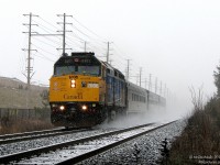 It's cold, it's snowing, it's Sunday, and we're freezing our bunions off. Initially braving the weekend winter weather to catch a hot Goderich Exeter Railway export special with what turned out to be a single boring FLP Class 66 for the UK (which of course happened to speed by just as we walked in to our photo spot), it was decided to stick around and wait for the regular afternoon VIA, and whatever else may be around. Naturally at this time it began to snow. But when life gives you snow, you make use of that brand new bridge the city has just finished to wait under.
<br><br>
After half an hour of accumulation, a set of headlights suddenly comes into view in the distance. Rapidly advancing through the white abyss, Operation Lifesaver painted 6411 accelerates VIA 85 out of downtown Brampton, on time, with the F40 and three Budd cars kicking up a trail of freshly fallen snow in their wake. Just as quickly as it appeared, it was gone - returning the scene back to quiet falling snow.
