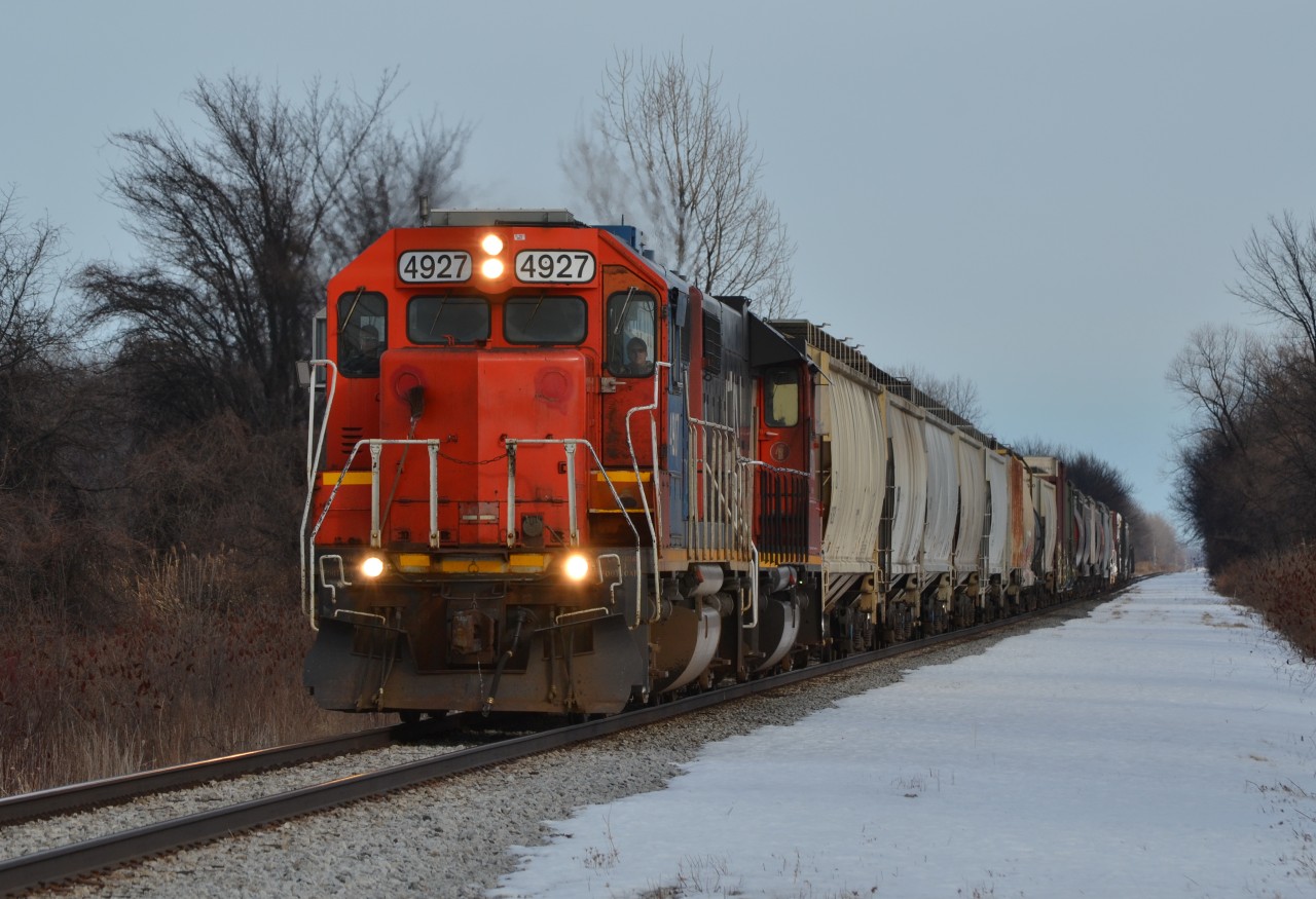 CN train A439, arriving into the outskirts of Windsor, in Lakeshore, Ontario. GTW 4927 & CN 4700 lead a 30ish Car train, pass the Hiram Walkers Warehouse's, and you can also see where the old second Main was.