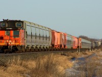 A rare site these days, A caboose on a mainline potash train crosses the not so flat prairies.