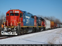 The Brakeman rides the steps of rare blue Grand Trunk GP38-2 #4927 as is approaches Wallace Line in Puce, Ontario today.  Slow orders for crossings and bridges keep the train moving relatively slow on the Windsor end of the Chatham sub, but the slow orders only apply to the freight traffic and not the regular VIA trains.