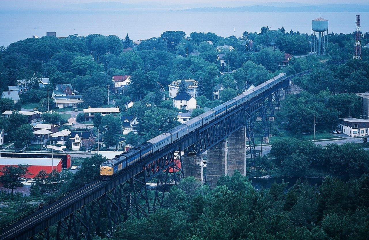 Love the F


Absolute and forever a Classic


Unbelievable that in 2014, sixty years after the first rolled out of GMD, an F is operating daily in Ontario!


To celebrate, and how appropriate, with an unidentified trio... a generic celebration.... a classic GMD built A – B – B  lashup leads Via's version of the Toronto section of the Canadian, the daily VIA #10, southbound across the iconic Seguin River Viaduct. 


Certainly this location is one of the top ten iconic Canadian Railway Sites.


Three miles south of this location, at CP Rail Reynolds, Parry Sound Subdivision,  #10 will use the interchange track to CN Boyne on the CN Bala Subdivision then to the Newmarket Subdivision at Washago.


What's interesting:


 The last F's to operate on trains 1, 2, 9 and 10 were steam generator equipped B units providing heat to the un-rebuilt conventional equipment (primarily CC&F, PS and Budd built) while the then new  ( 1989 GMD built ) F40PH2 units provided primary motive power.


Reportedly Via placed the Dining Room Car at the rear of  trains 9 and 10  (immediately in front of the Park Observation car)  to discourage coach passengers from overwhelming the dining room facilities.


 And on this train #10 an ex CP Rail Dining Room Car is dead-heading at the front of the consist. 


An ex CN coach – cafe was the regular substitute for the ex CP Rail Skyline Dome ( from Vancouver) that was assigned to the Montreal section, train #2.


And enough Sudbury – Toronto passengers to fill the three coaches ! ( and where is Via today on this route ? )


Today the freight rail traffic at this site is now primarily northbound ?


On a hot, humid and very hazy August 10, 1985, Kodachrome by S.Danko


Love the F


sdfourty