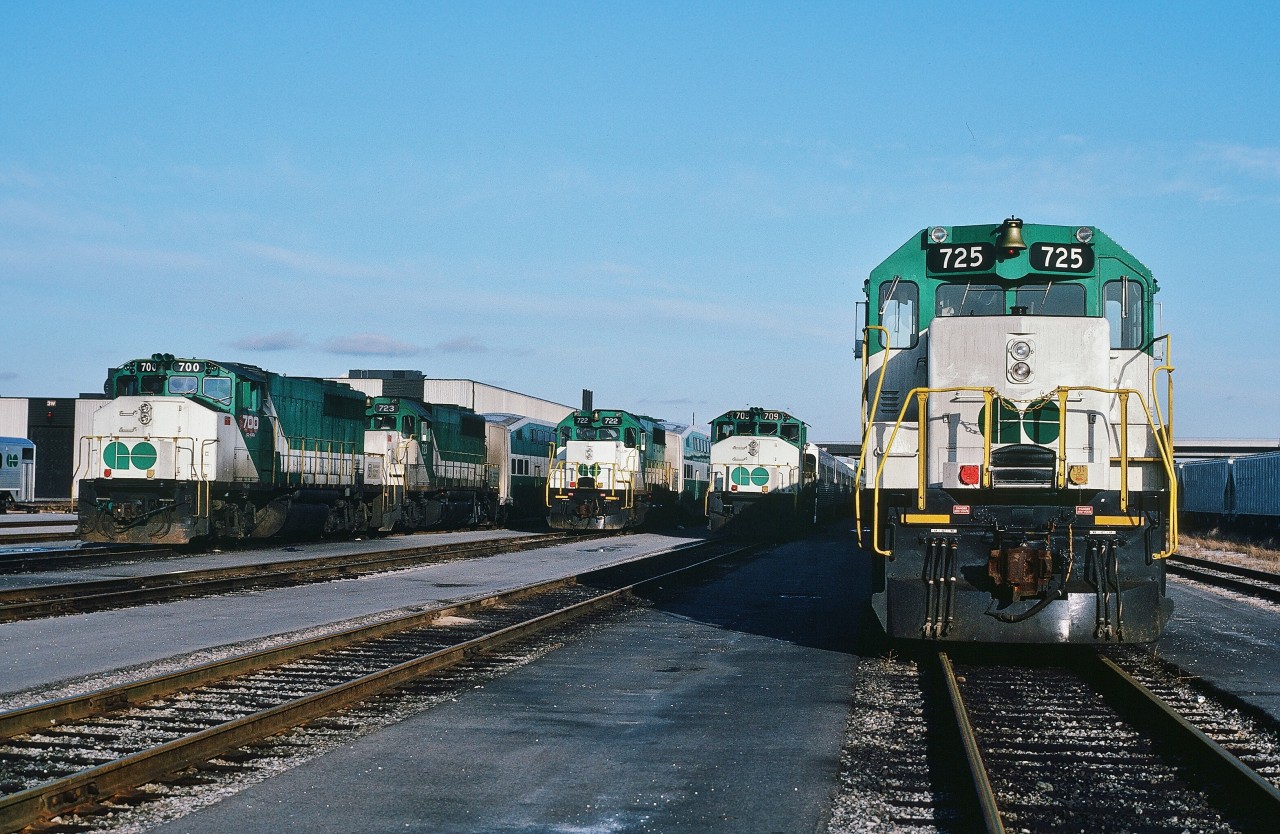 What ?  Go Transit interesting? ... how time changes perspective ...


When Willowbrook opened a friend suggested we sign a release and explore. So we did.


So, for the EMD - GMD fans, at the west end of the storage / service tracks, as built, starting from the left (info from the Trackside Guide):


GO 700: built by GMD GP40-2(W), 1973; sold to CN 9661 in 1991 and re-sold to Progress Rail in February 2002.


GO 723: built by EMD GP40-M-2, 1967; for the Chicago Rock Island & Pacific #377 (then to RI #3001), acquired * by GO 723 in 1982 then traded by GO to EMD in 1993 for new F59PH #565; GO 723 then re-sold by EMD to LLPX 3205 


GO 722: built by EMD GP40-M-2, 1967; for the Chicago Rock Island & Pacific #376 (then to RI #3003), acquired * by GO 722 in 1982 then traded by GO to EMD in 1993 for new F59PH #564; GO 722 then re-sold by EMD to LLPX 3211


GO 709: built by GMD GP40-2(W), 1975; sold to CN 9676 in 1991 and as of 2005 in service (today?)


GO 725: built by EMD GP40-M-2, 1967; for the Chicago Rock Island & Pacific #380 (then to RI #3004), acquired * by GO 725 in 1982 then traded by GO to EMD in 1993 for new F59PH #567; GO 725 then re-sold by EMD to LLPX 3203


At Willowbrook in Mimico, January 2, 1983  Kodachrome by S.Danko


What's interesting:


In 1982: GO acquired * seven ex Chicago Rock Island & Pacific units #3000-3006.


 * likely as part of the CRI&P asset sale by the bankruptcy trustee.


For all ten bi-level car trains, the 'double header' was the common lash-up when an ex Rock Island unit was assigned.


No electronic bells here, GO engines with real ding dong bells.


The ditch lights to be standard equipment on the 1988-94 GMD built F59PH's.


Note GO 709's train is a combination of single level (essentially modified subway cars) Hawker Siddeley built coaches  and bi-level coaches. 


The newest bi-level's were but five years old !


And the first bi-level control cabs arrived 1983, necessitating the continued use of  single level control cabs cars  well into the mid 1980's.


Image of the east end of these trains: 


  the ACPU's   


sdfourty.