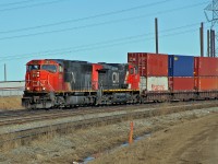 SD70I CN 5615 and DASH9-44CW CN 2653 ease a westbound intermodal through Clover Bar.